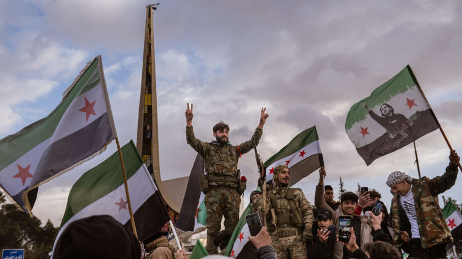 DAMASCUS, SYRIA - DECEMBER 27: Syrians gather in the Umayyad Square, waving the Syrian revolution flags as they continue their celebrations after the overthrow of the 61-year Baathist regime and the end of the Assad family era in Damascus, Syria on December 27, 2024. (Photo by Emin Sansar/Anadolu via Getty Images)