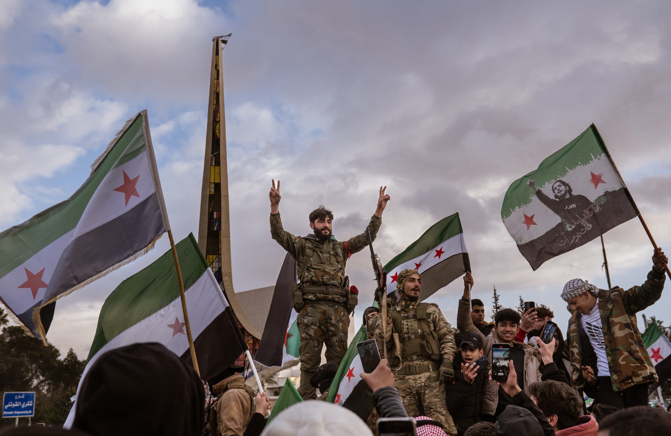DAMASCUS, SYRIA - DECEMBER 27: Syrians gather in the Umayyad Square, waving the Syrian revolution flags as they continue their celebrations after the overthrow of the 61-year Baathist regime and the end of the Assad family era in Damascus, Syria on December 27, 2024. (Photo by Emin Sansar/Anadolu via Getty Images)