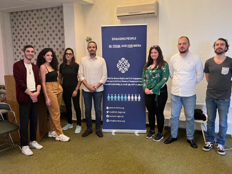 HuMENA team standing with our banner